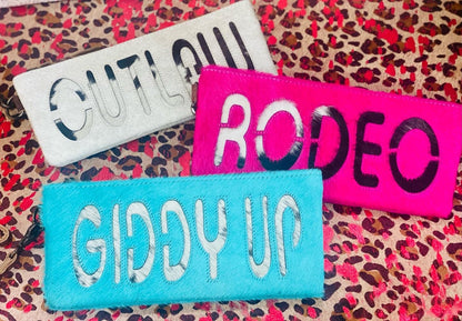 The Rodeo Cowhide Clutch Collection